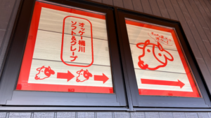 オッケー桶川ソフト＆クレープの案内板。牛のキャラクターが「そのまままっすぐでオッケー！」と伝えてくれている